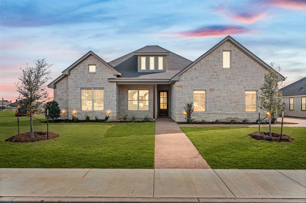 900 Day Star Drive Hewitt, TX 76643 - Photo 1 of 40 View of front of property featuring stone siding, a front lawn, a shingled roof, and covered porch