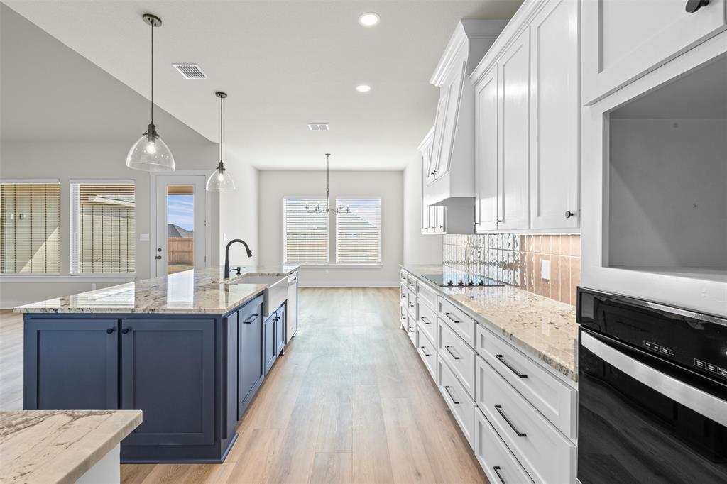 900 Day Star Drive Hewitt, TX 76643 - Photo 20 of 40 Kitchen featuring white cabinetry, light stone countertops, oven, hanging light fixtures, and recessed lighting