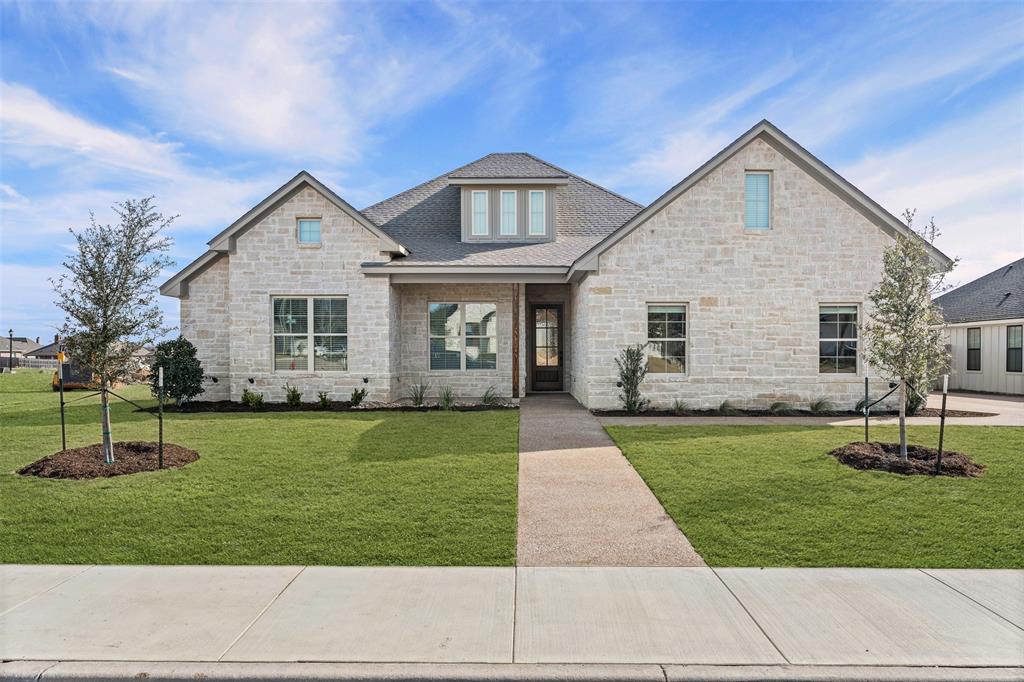900 Day Star Drive Hewitt, TX 76643 - Photo 2 of 40 View of front of property with stone siding, a front lawn, a shingled roof, and covered porch