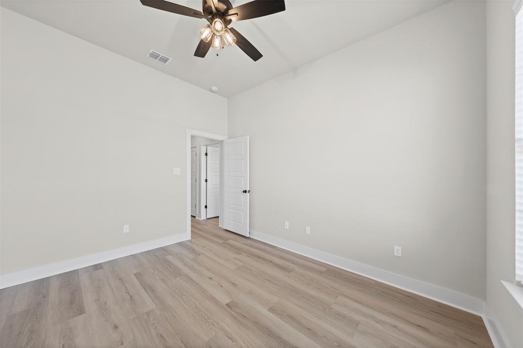 900 Day Star Drive Hewitt, TX 76643 - Photo 29 of 40 Empty room with light wood-type flooring, ceiling fan, and a high ceiling