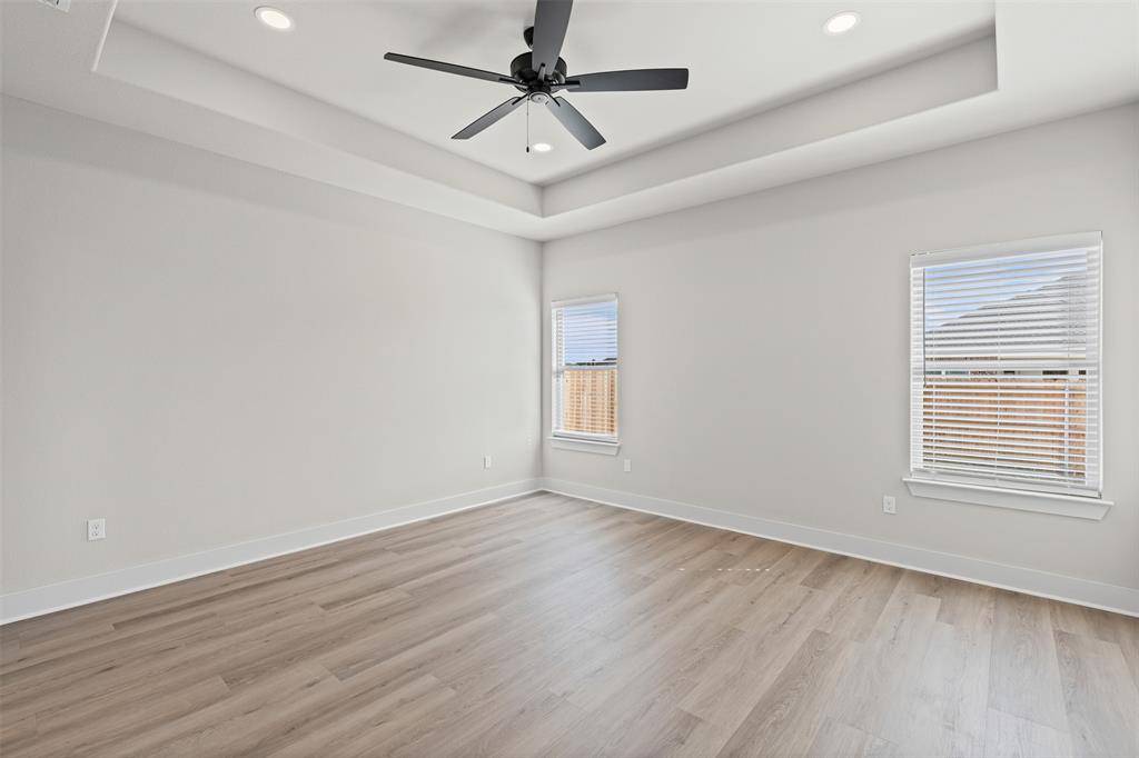 900 Day Star Drive Hewitt, TX 76643 - Photo 34 of 40 Unfurnished room featuring recessed lighting, a tray ceiling, light wood-type flooring, and a ceiling fan