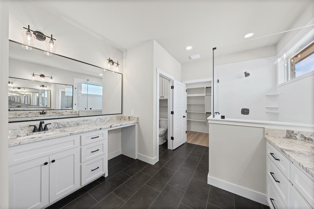 900 Day Star Drive Hewitt, TX 76643 - Photo 36 of 40 Bathroom with vanity, a spacious closet, dark tile patterned floors, plenty of natural light, and recessed lighting