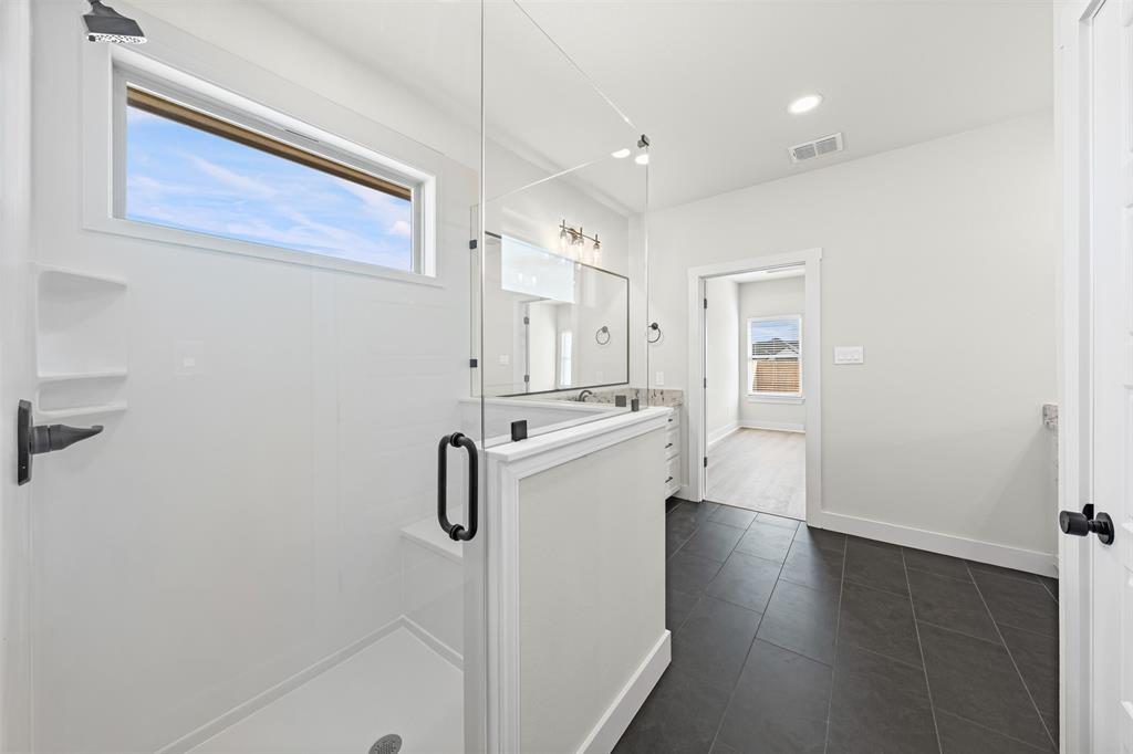 900 Day Star Drive Hewitt, TX 76643 - Photo 39 of 40 Full bathroom with vanity, a stall shower, dark tile patterned floors, and recessed lighting