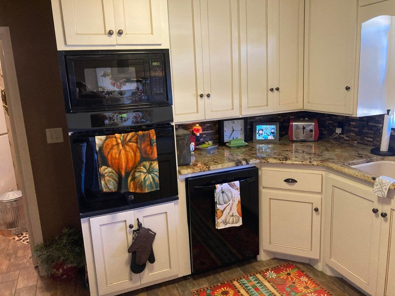 715 Denver Plainview, TX 79072 - Photo 18 of 45 a kitchen with stainless steel appliances granite countertop a stove and cabinets