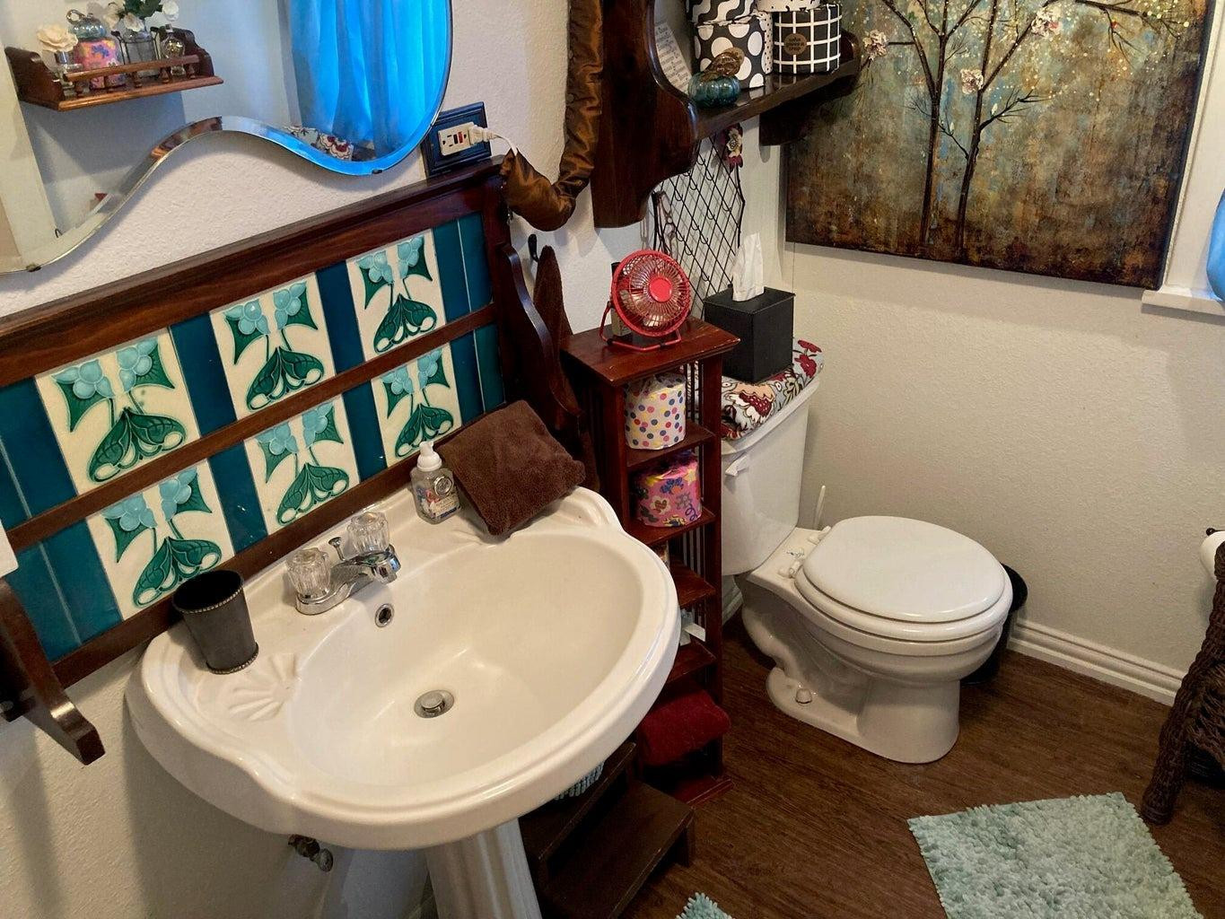 715 Denver Plainview, TX 79072 - Photo 37 of 45 a bathroom with a toilet sink and mirror