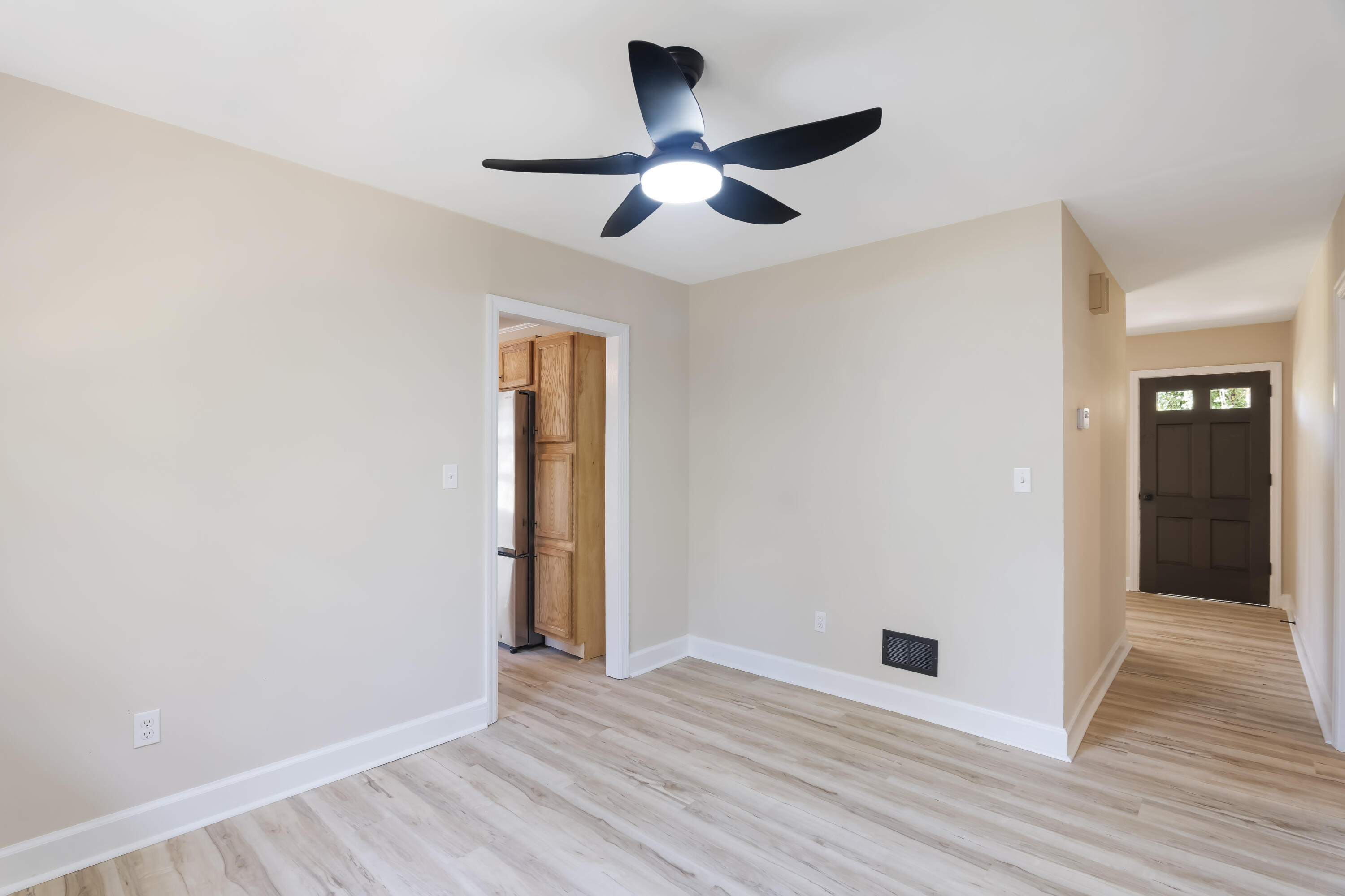 39 Gantt Street Wagener, SC 29164 - Photo 5 of 30 an empty room with wooden floor and a ceiling fan