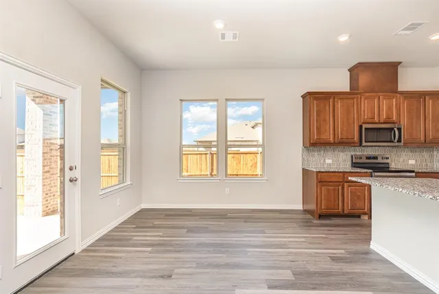 a view of a kitchen counter top space and wooden floor