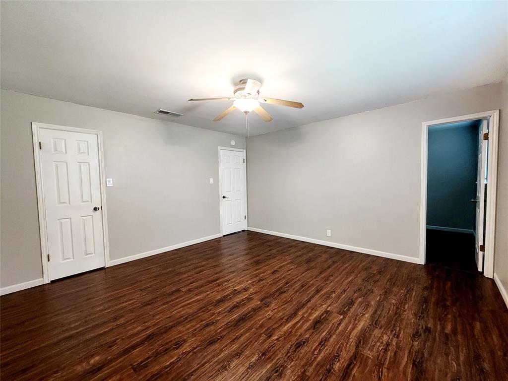 3514 Buchanan Loop Road Texarkana, TX 75501 - Photo 17 of 40 a view of an empty room with wooden floor and a ceiling fan
