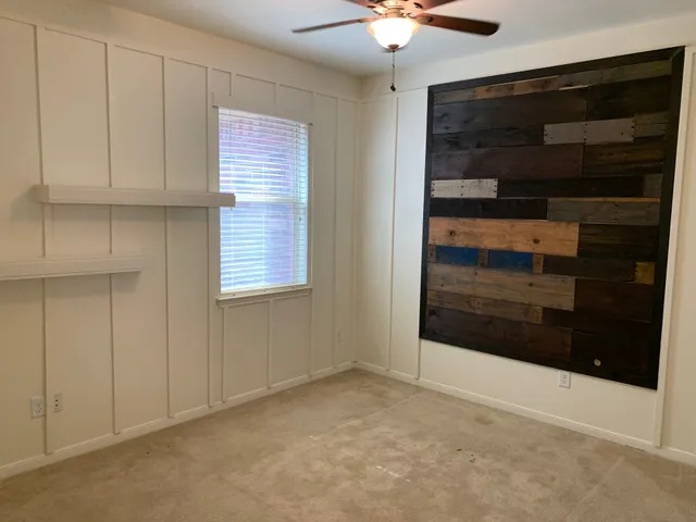 a view of an empty room with a fireplace