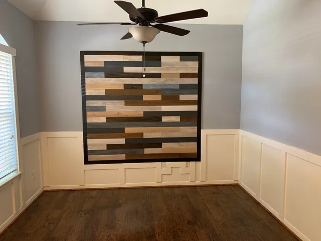 a view of a hallway with wooden floor and chandelier