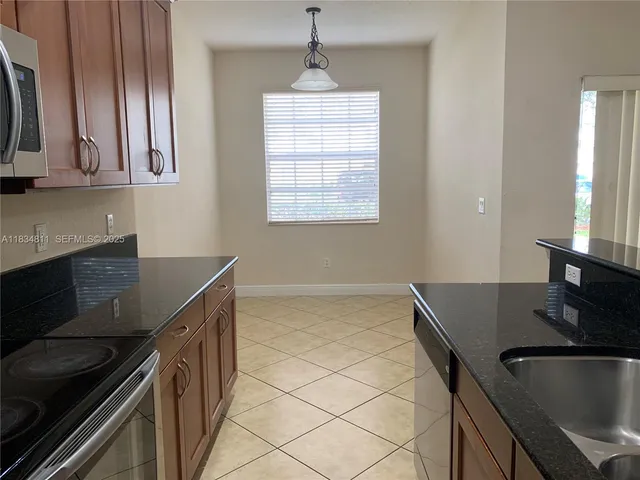 a kitchen with a sink appliances and cabinets