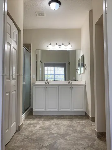 a white toilet sitting next to a white wall