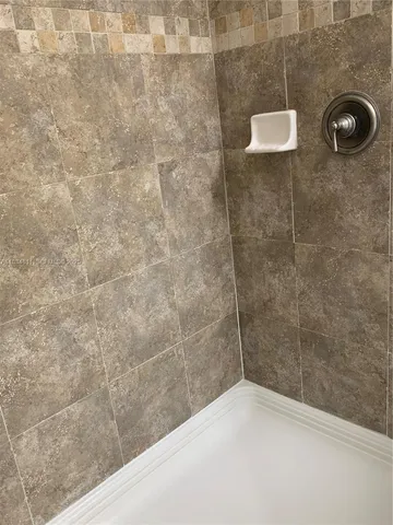 a white toilet sitting next to a bathroom sink