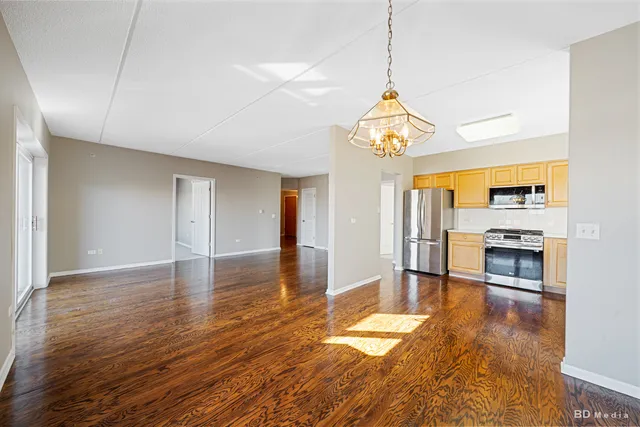 a view of a room with wooden floor fireplace and a window