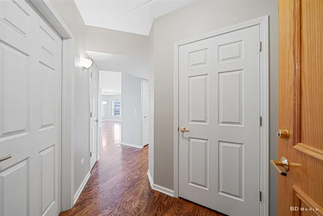 a view of a room with wooden floor