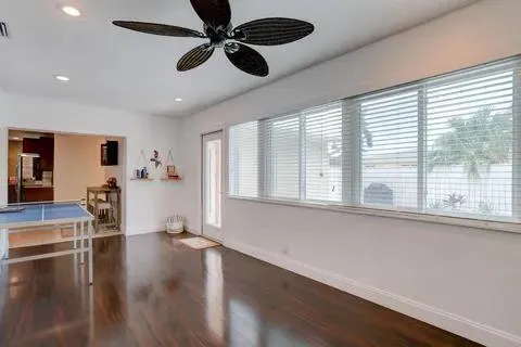 a view of a livingroom with furniture wooden floor and a window