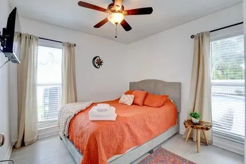 a bedroom with a bed and a chandelier