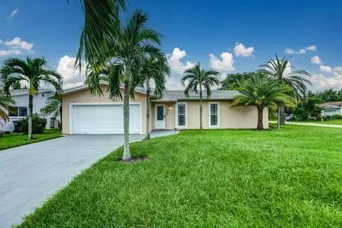 a front view of house with yard and outdoor seating