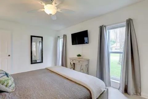 a bedroom with a bed and a flat screen tv
