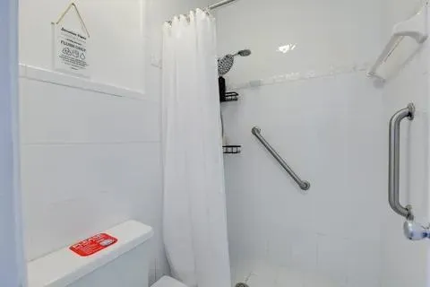 a bathroom with a shower and a sink