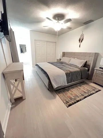 a spacious bedroom with a bed and a couch