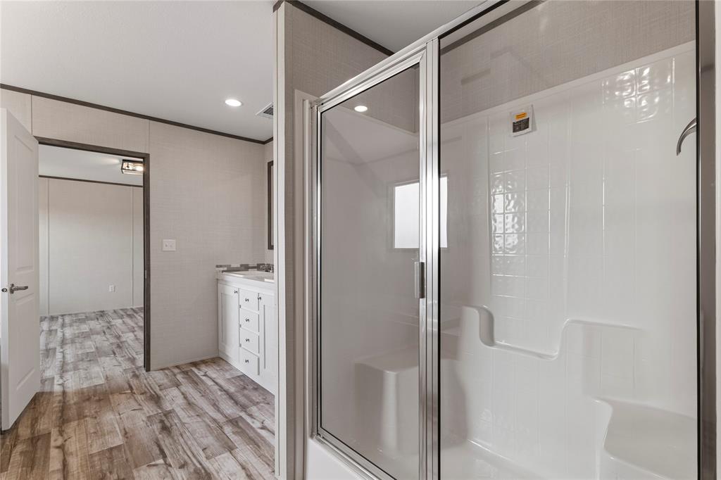 3924 Sandusky Road Whitesboro, TX 76273 - Photo 18 of 22 Full bathroom with vanity, a stall shower, ornamental molding, recessed lighting, and light wood-style floors