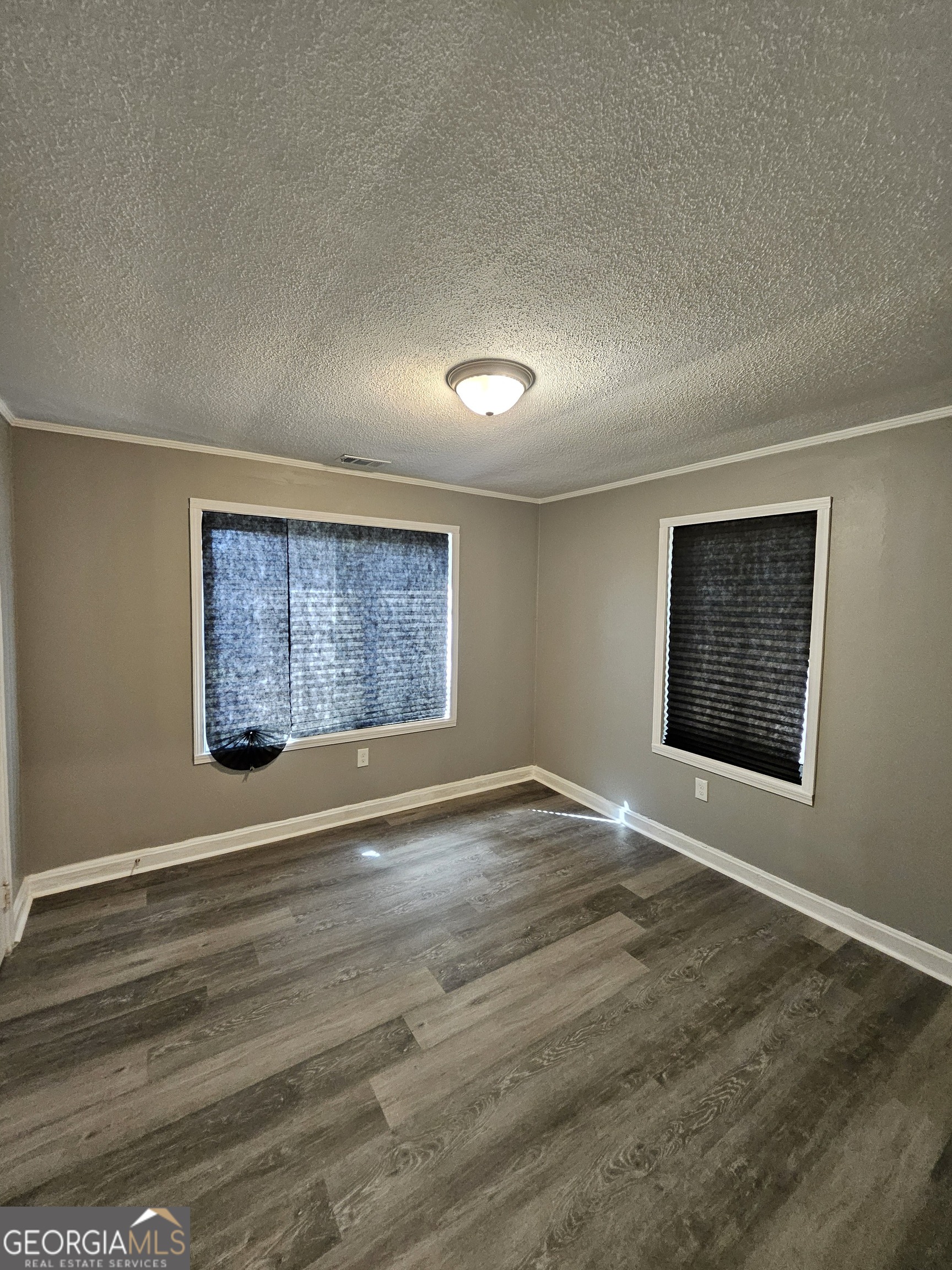 521 Meriwether Street, Unit C Griffin, GA 30224 - Photo 4 of 11 a view of an empty room with a window
