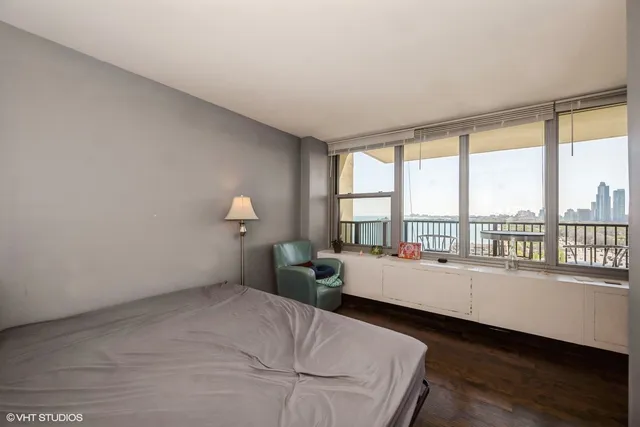 a bedroom with furniture and a large window