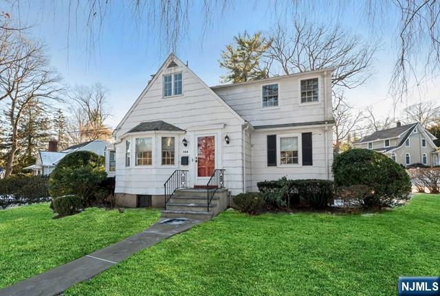 a front view of a house with a garden and plants