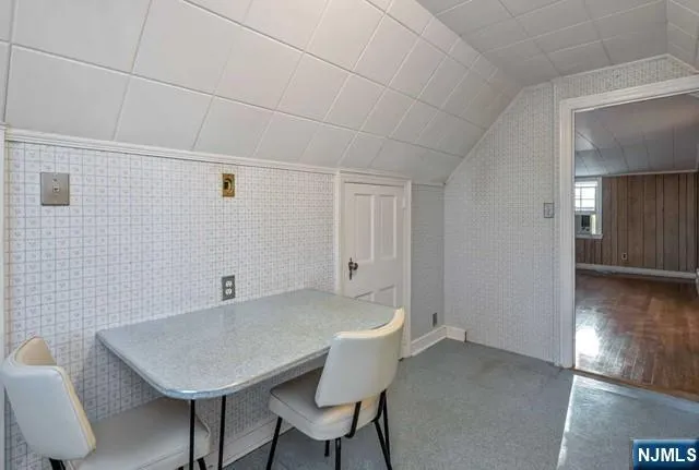 a view of a room with furniture and wooden floor