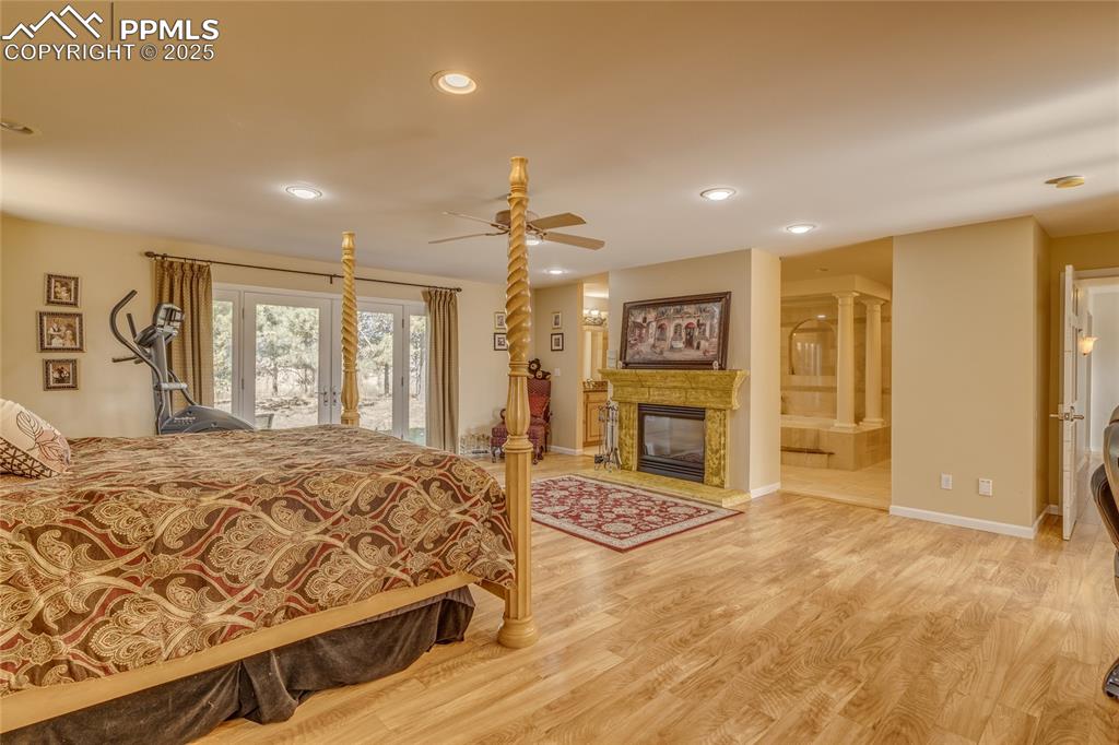 15410 South Perry Park Road Larkspur, CO 80118 - Photo 11 of 28 a spacious bedroom with a large bed and a dresser