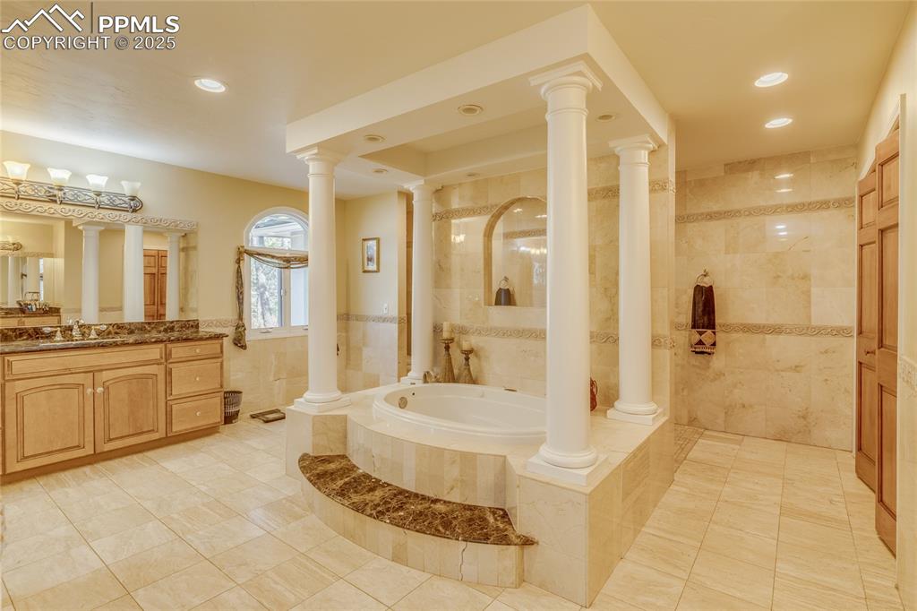 15410 South Perry Park Road Larkspur, CO 80118 - Photo 13 of 28 a bathroom with a tub shower sink and mirror