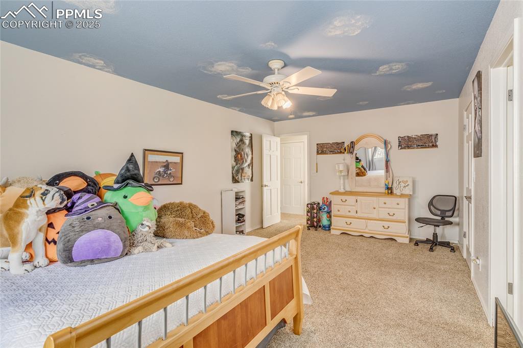 15410 South Perry Park Road Larkspur, CO 80118 - Photo 21 of 28 a bedroom with furniture and a bed