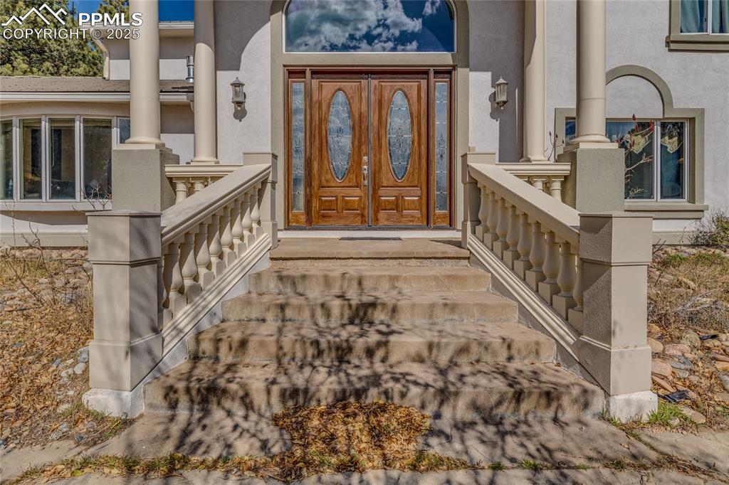 15410 South Perry Park Road Larkspur, CO 80118 - Photo 3 of 28 a view of an entryway with staircase