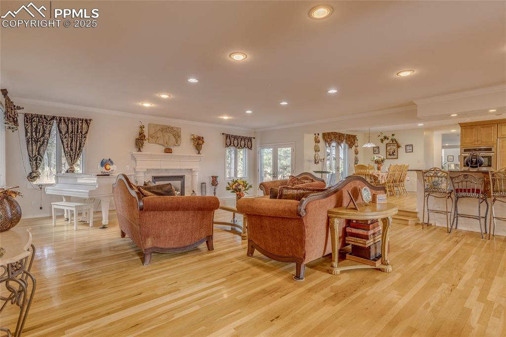 15410 South Perry Park Road Larkspur, CO 80118 - Photo 6 of 28 a living room with furniture and a wooden floor