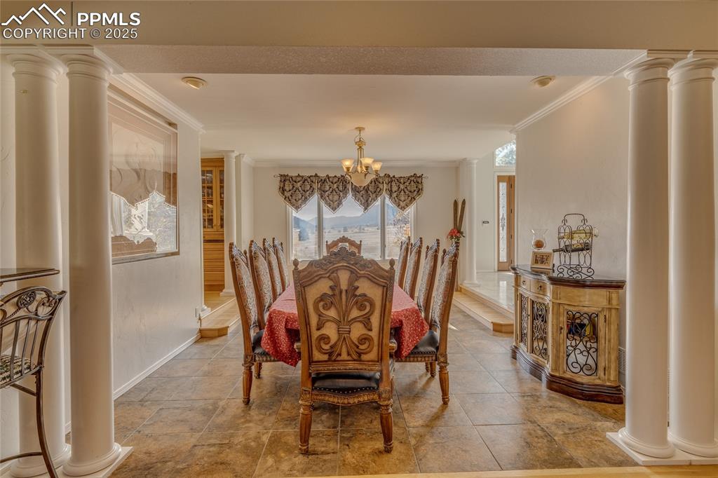 15410 South Perry Park Road Larkspur, CO 80118 - Photo 7 of 28 a view of a dining room with furniture and chandelier
