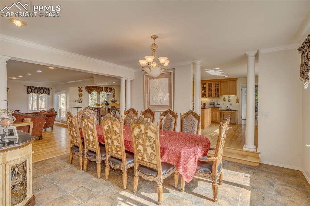 15410 South Perry Park Road Larkspur, CO 80118 - Photo 8 of 28 a view of a dining room with furniture and chandelier