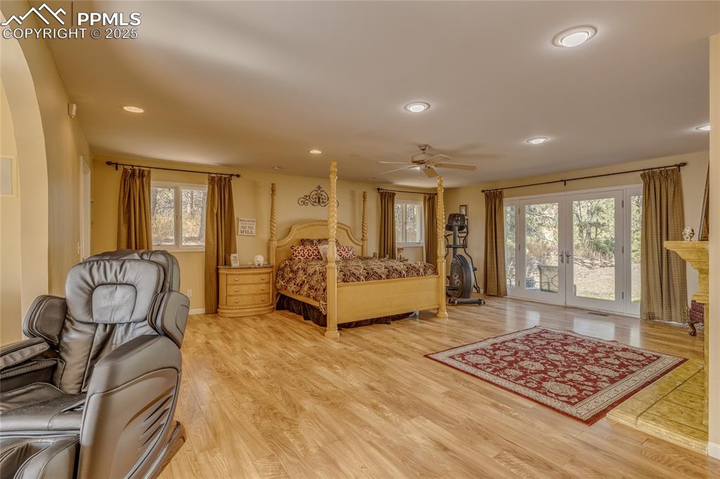 15410 South Perry Park Road Larkspur, CO 80118 - Photo 9 of 28 a spacious bedroom with a bed a table and a dresser