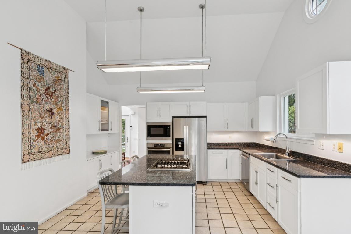 2102 South Road Baltimore, MD 21209 - Photo 12 of 37 a kitchen with stainless steel appliances granite countertop a sink and a stove