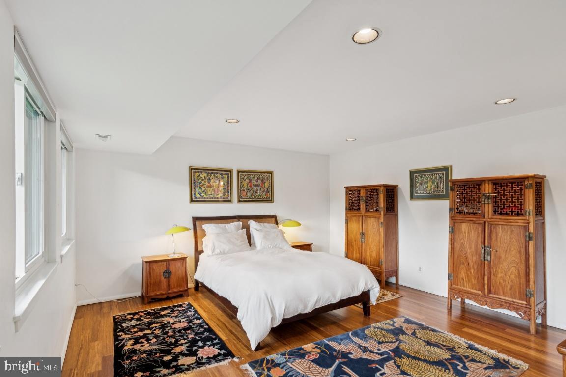 2102 South Road Baltimore, MD 21209 - Photo 20 of 37 a bedroom with a bed and wooden floor