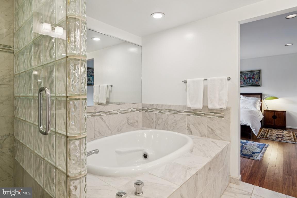 2102 South Road Baltimore, MD 21209 - Photo 24 of 37 a bathroom with a tub a sink and a shower