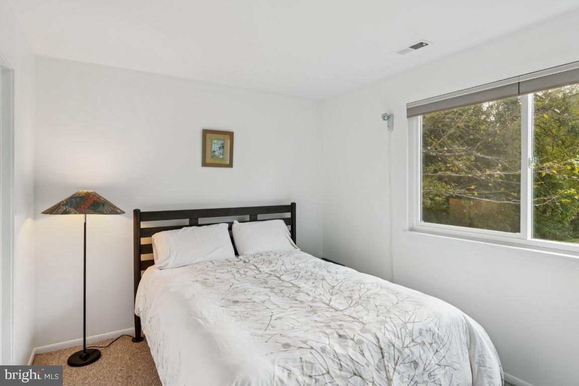 2102 South Road Baltimore, MD 21209 - Photo 25 of 37 a bedroom with a bed and a window