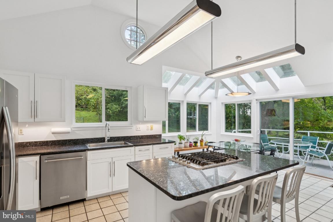 2102 South Road Baltimore, MD 21209 - Photo 10 of 37 a kitchen with granite countertop a sink a counter top space cabinets and stainless steel appliances