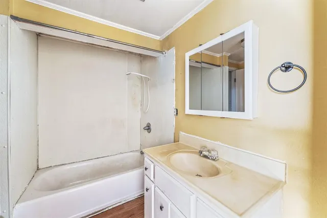 a view of a big yard with plants and large trees