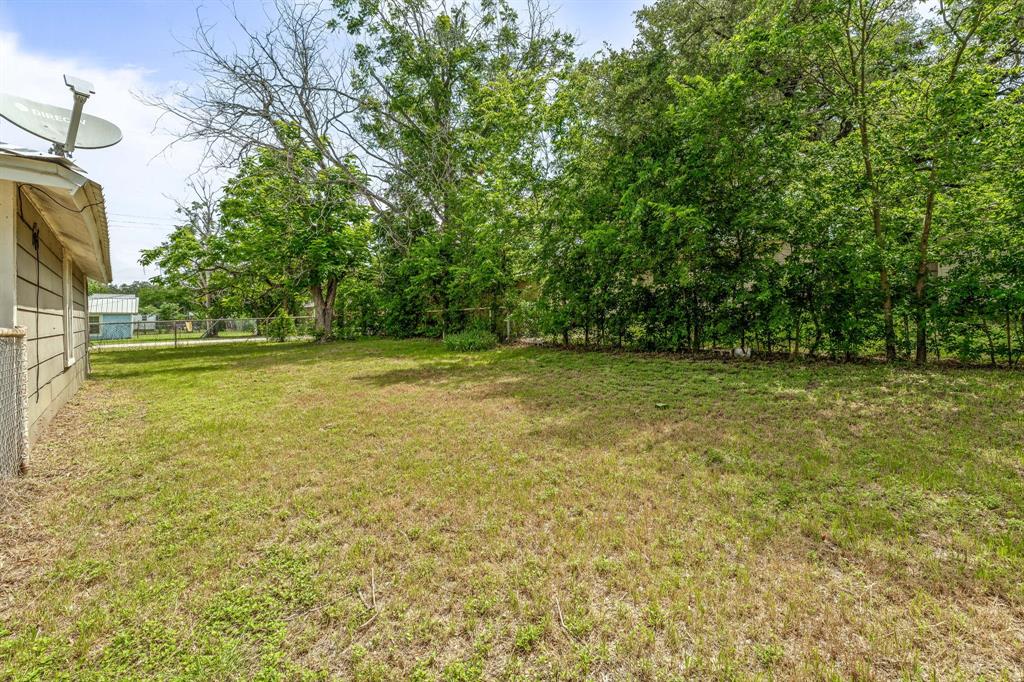 400 South Pecan Street Hamilton, TX 76531 - Photo 13 of 19 a view of a big yard with plants and large trees