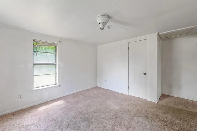 a kitchen with granite countertop appliances a sink cabinets and a window