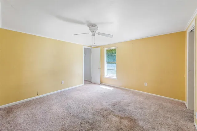 a view of empty room with ceiling fan