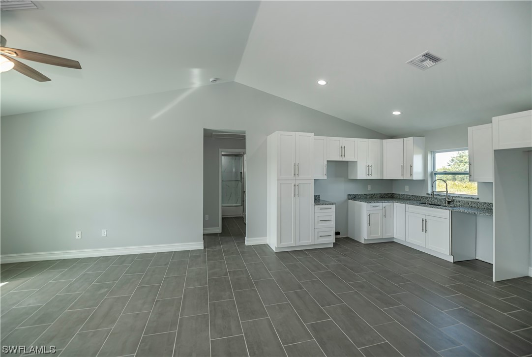 9024 Largo Circle LaBelle, FL 33935 - Photo 11 of 27 a large kitchen with stainless steel appliances a refrigerator and white cabinets