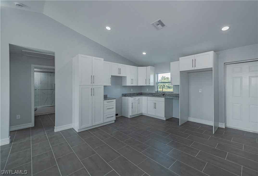 9024 Largo Circle LaBelle, FL 33935 - Photo 12 of 27 a kitchen with stainless steel appliances a refrigerator sink and cabinets