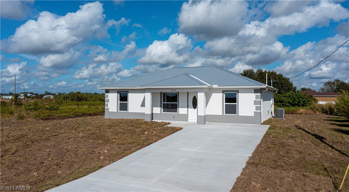 9024 Largo Circle LaBelle, FL 33935 - Photo 2 of 27 a front view of a house with a yard and garage